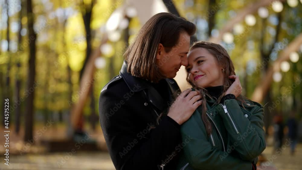 man is hugging tenderly his beloved girlfriend in forest in autumn man is hugging tenderly his beloved girlfriend in forest in autumn