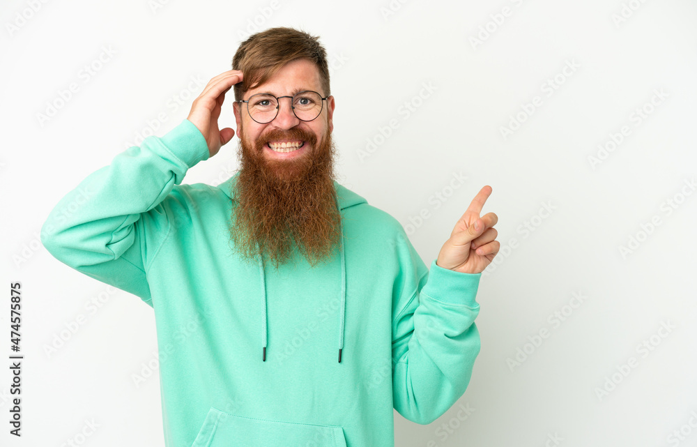 Young reddish caucasian man isolated on white background surprised and pointing finger to the side Young reddish caucasian man isolated on white background surprised and pointing finger to the side