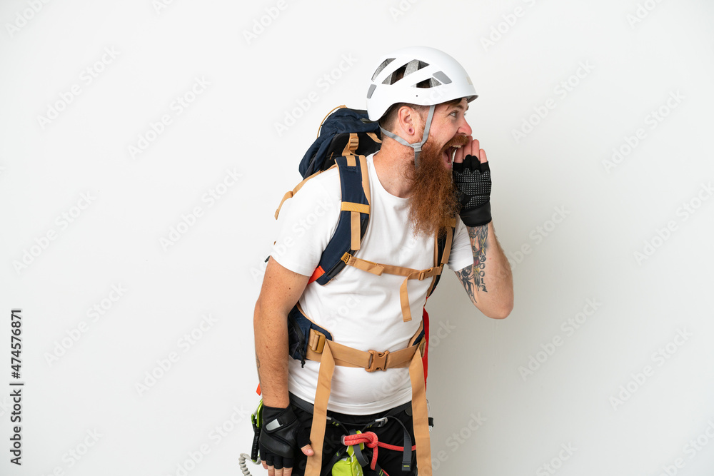 Young rock- climber reddish caucasian man isolated on white background shouting with mouth wide open to the side Young rock- climber reddish caucasian man isolated on white background shouting with mouth wide open to the side