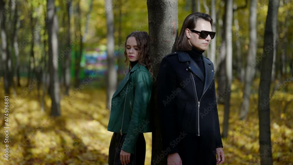 strange relationship of man and woman, trouble in couple, lady and her boyfriend in park in autumn strange relationship of man and woman, trouble in couple, lady and her boyfriend in park in autumn