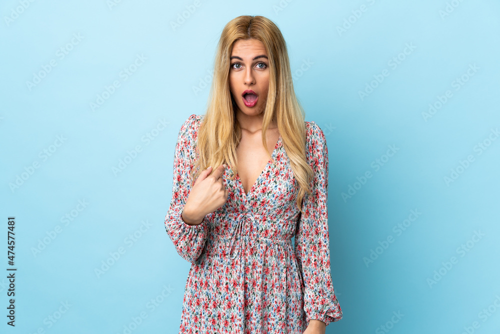 Young Uruguayan blonde woman over isolated blue background pointing to oneself Young Uruguayan blonde woman over isolated blue background pointing to oneself