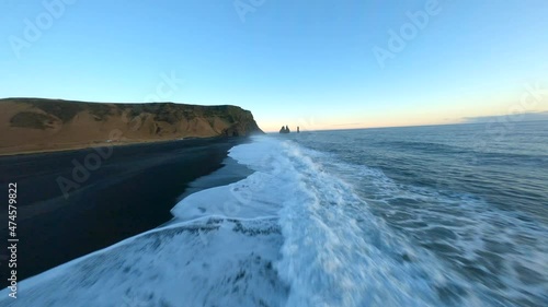 Aerial fpv view of black beach Vik during sunset, Iceland. 