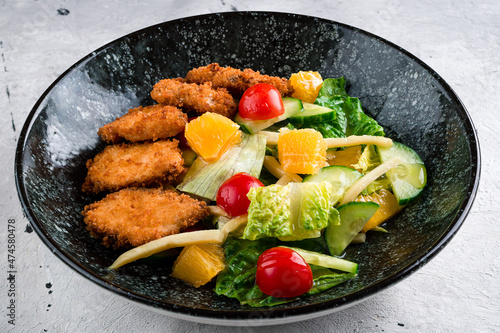 Colorful vegetable dish with mixed orange, nuggets, lettuce and tomatoes. Beautiful view of restaurant healthy food