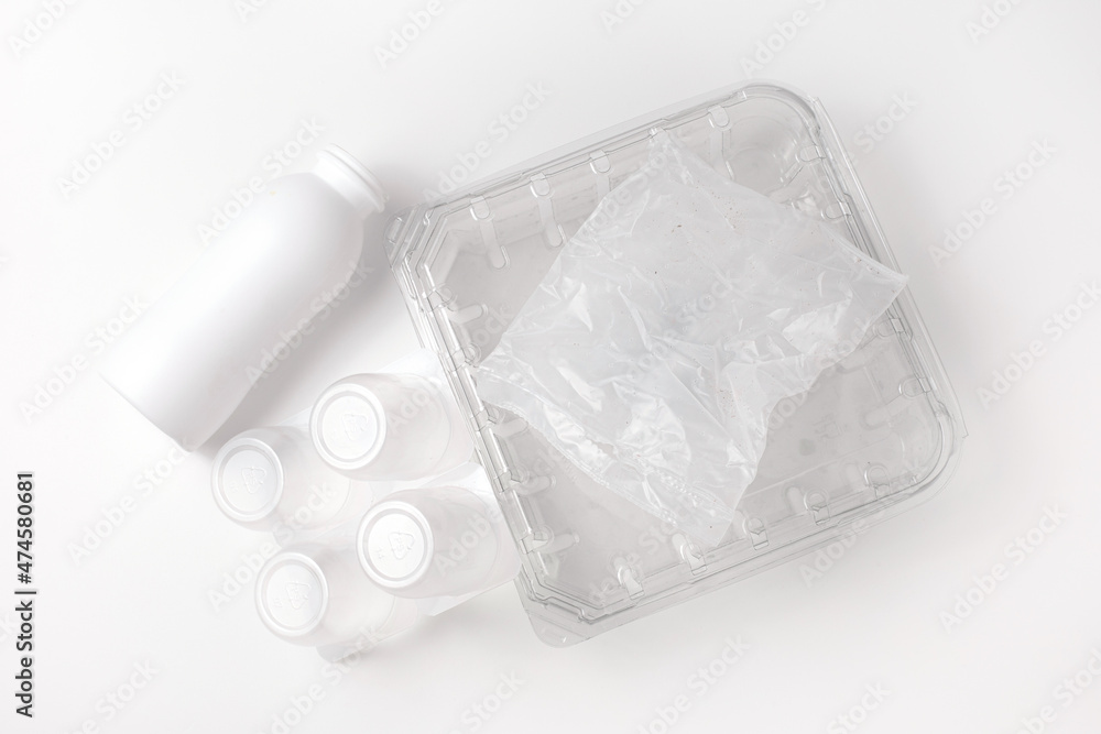 Heap of plastic garbage, trash on white background. Concept of Recycling plastic and ecology. Flat lay, top view.