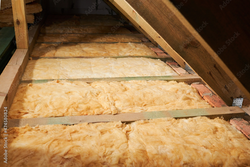 Warming of the roof with mineral wool. Repairing of the house, floor heating insulation, warm attic, eco-friendly insulation - obrazy, fototapety, plakaty 