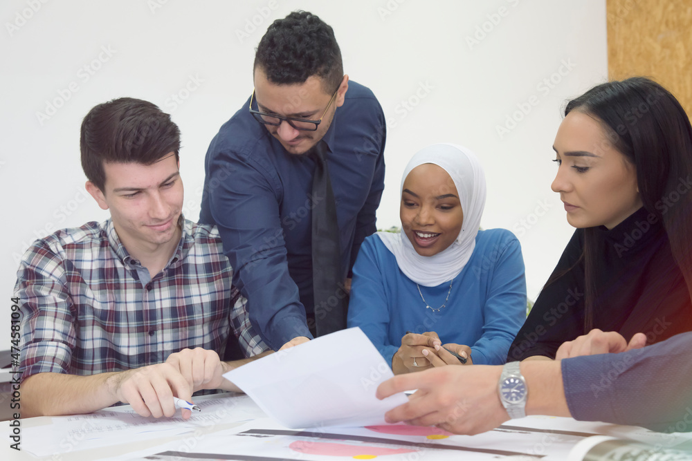 Talented group of international students cooperating together with professor on technical planning during lesson in modern university classroom Talented group of international students cooperating together with professor on technical planning during lesson in modern university classroom