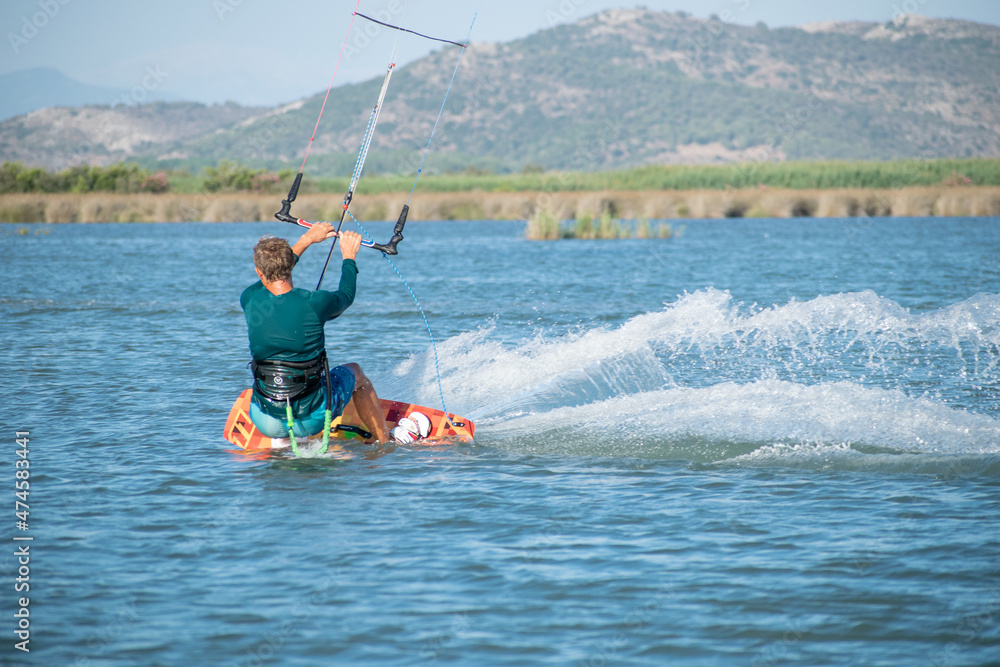 Fototapeta premium Kitesurfer athlete surfing on sea surface