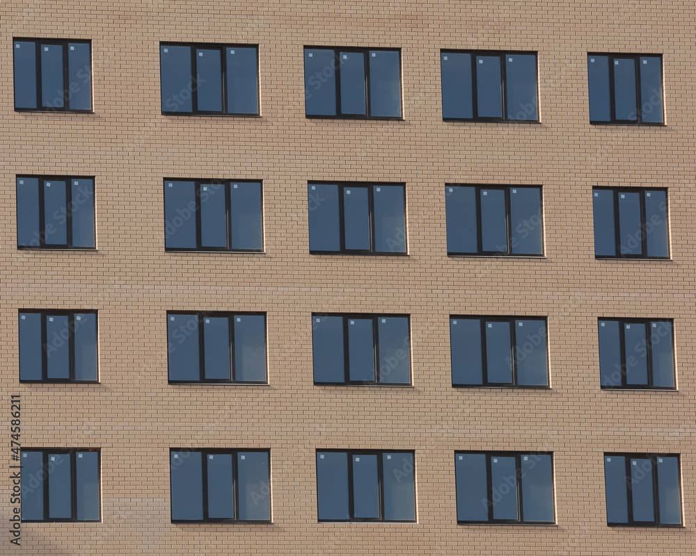 Windows of brick high-rise buildings.
