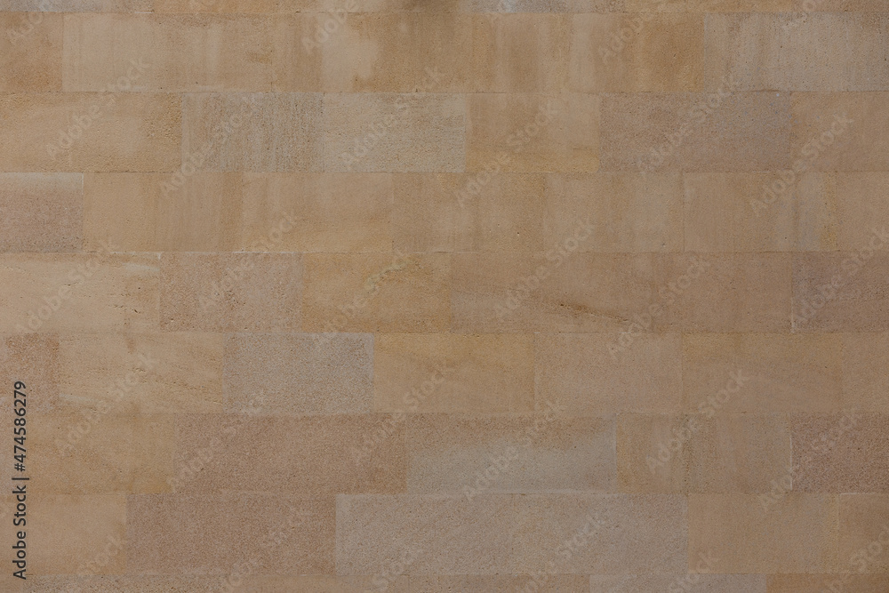 Fototapeta premium The wall is of sawn yellow sandstone.