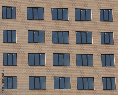 Windows of brick high-rise buildings. 