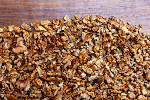 crushed walnuts on wooden background