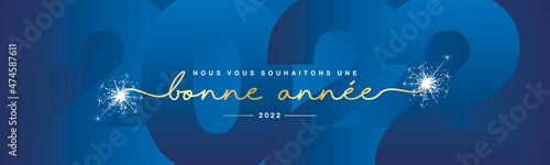 We wish you Happy New Year 2022 French language line designed handwritten lettering white blue background with sparkle firework