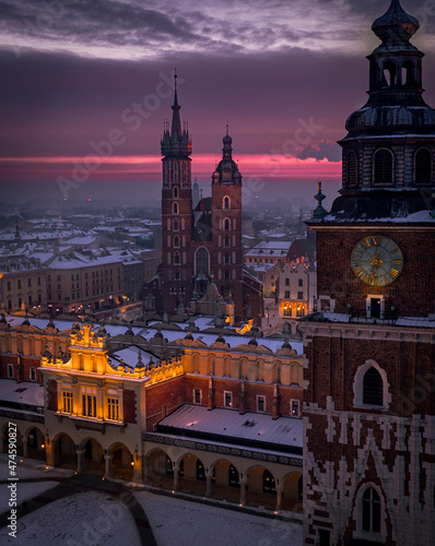 Main Square (Saint Mary's Basilica, Sukiennice - Town Hall, Town Hall Tower) in Krakow during magic dawn in winter, Poland