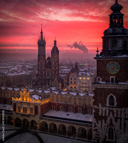Main Square (Saint Mary's Basilica, Sukiennice - Town Hall, Town Hall Tower) in Krakow during magic dawn in winter, Poland