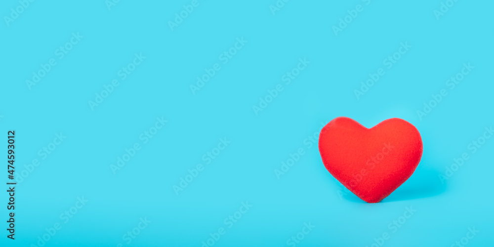 Red heart on blue background, health care, love, organ donation, family insurance,CSR,world heart day, world health day, praying concept.