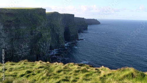 Beautiful landscape shot of the ocean and Cliffs of Moher in Ireland photo
