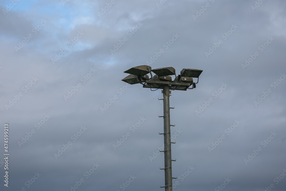 A pole with lanterns against the sky.