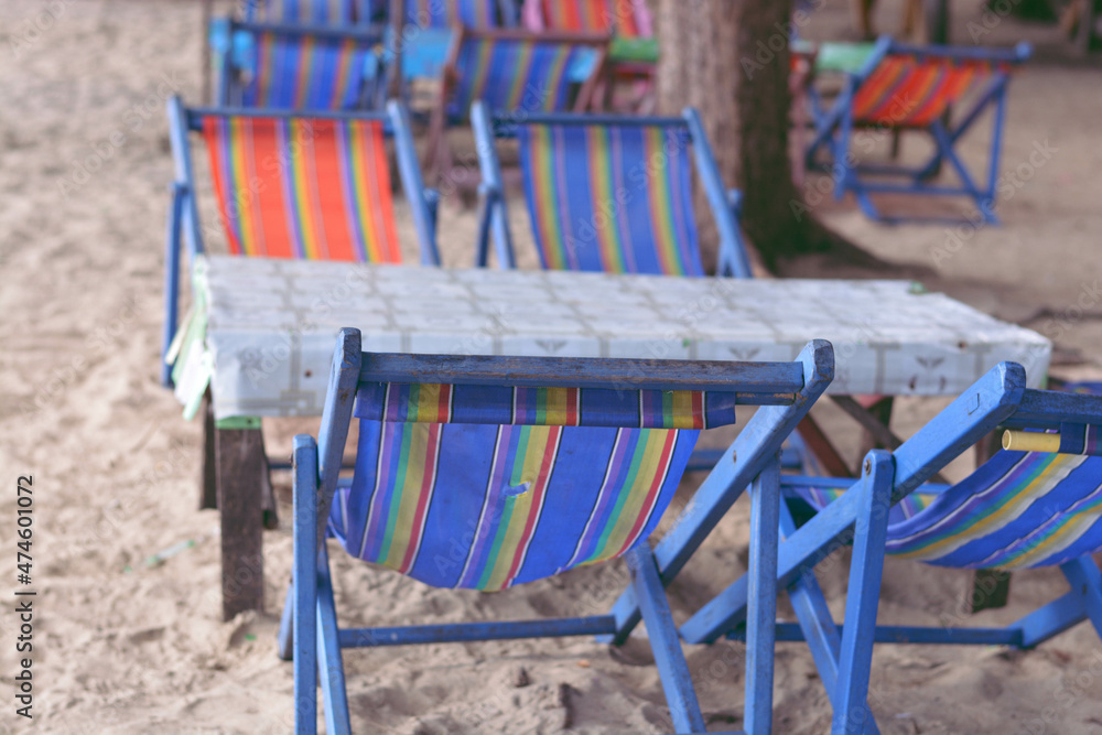 Beach chairs and small table on the seaside at Chanthaburi, Thailand. Selective focus.