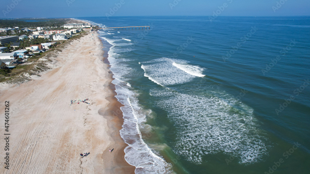 Aerial drone view of where the east coast of Florida meets the Atlantic Ocean as the waves crash on the sandy shores of St Augustine 