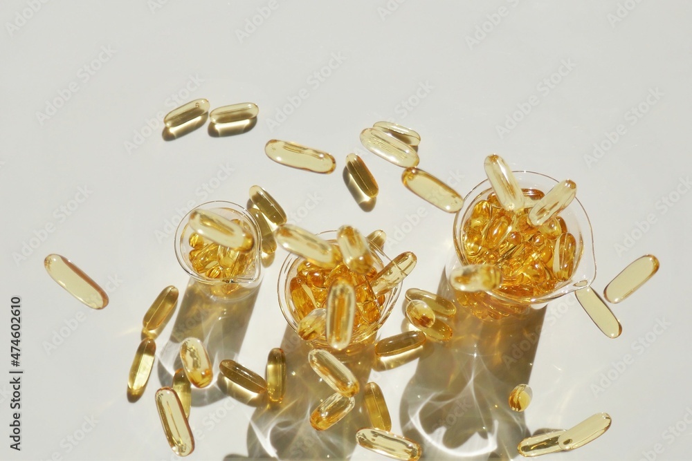 Fish oil capsules in laboratory transparent flasks on a white background.omega fatty acids.Natural supplements and vitamin.