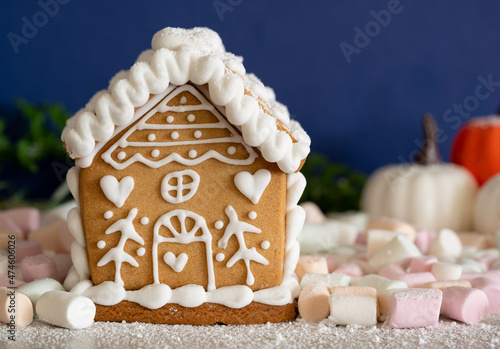 Ginger bread house with marshmallows and pumpkins 