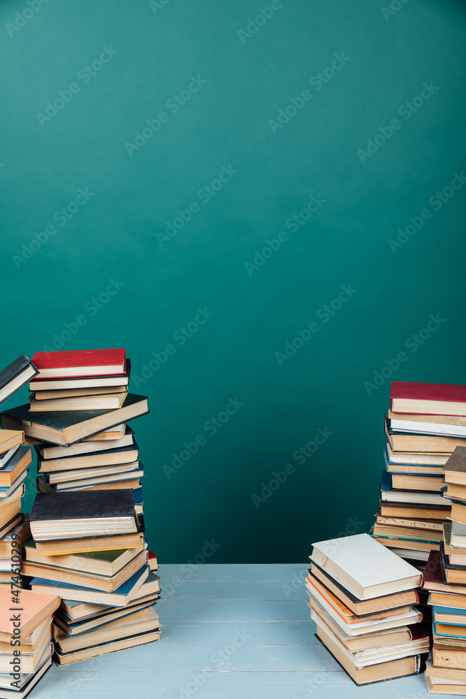 stacks of old books for learning in the library on a green background stacks of old books for learning in the library on a green background