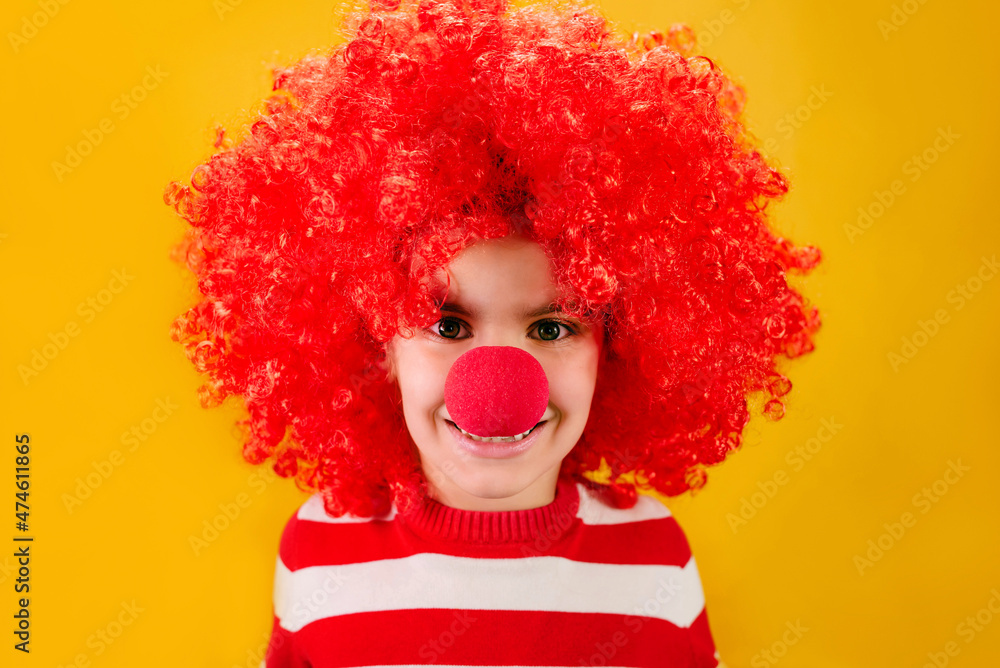 Let's celebrate! Funny kid clown playing at home. 1 April Fool's day concept.