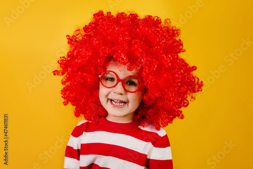 Let's celebrate! Funny kid clown playing at home. 1 April Fool's day concept.