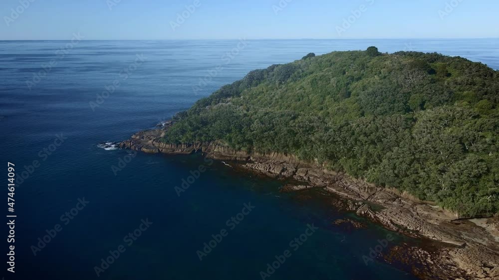 Aerial Approaching Goat Island Dense Tree Canopy Surrounded By Waveless Deep Blue Pacific Ocean, New Zealand Aerial Approaching Goat Island Dense Tree Canopy Surrounded By Waveless Deep Blue Pacific Ocean, New Zealand