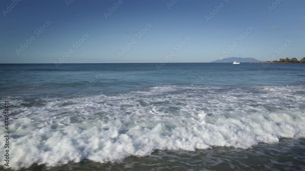 Ocean Waves Rollling At The Beach In Tawharanui Regional Park In New Zealand. - aerial sideways Ocean Waves Rollling At The Beach In Tawharanui Regional Park In New Zealand. - aerial sideways