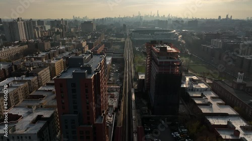 flying behind subway train in the Bronx towards NYC skyline photo