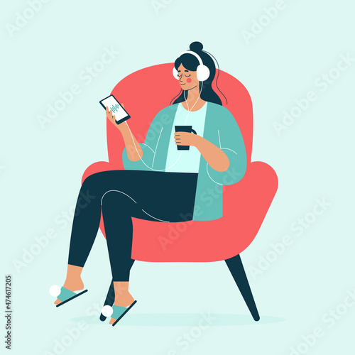 A young woman sits in a chair at home with a cup of tea and listens to a podcast with headphones, a woman listens to music, meditation. Vector illustration in a flat style.