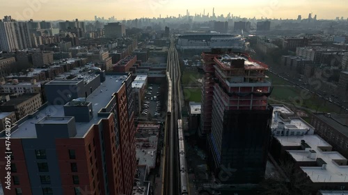 flying over crossing subway trains in the Bronx towards NYC skyline photo