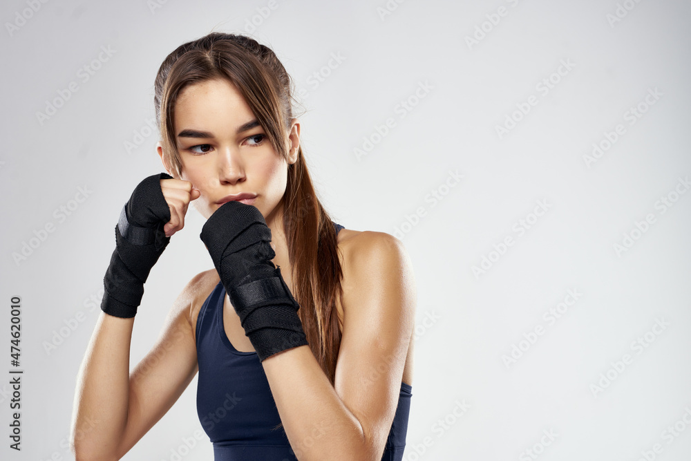Fototapeta premium athletic woman boxing workout punching exercise light background