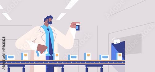 man operator controlling medicine production filling on conveyor belt doctor checking quality of products