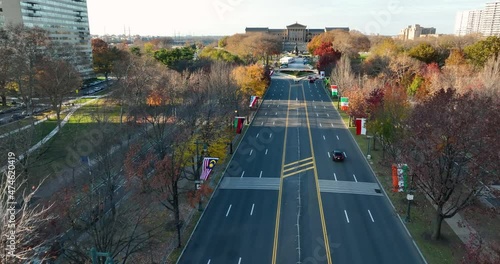 Aerial above Benjamin Franklin Parkway in Philadelphia, PA. Drone approach Museum of Art past international flags. photo