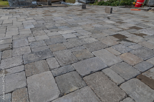 Closeup shot of a newly built concrete paver patio hardscape surface being installed in a landscape