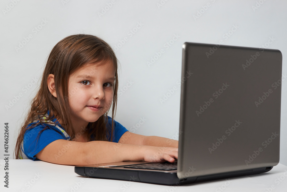 Child girl enjoy e-learning on computer notebook Child girl enjoy e-learning on computer notebook