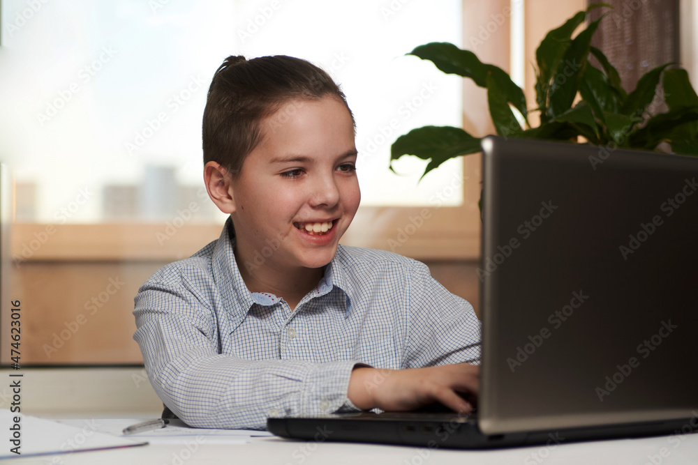 Teenage boy enjoy e-learning on computer notebook
