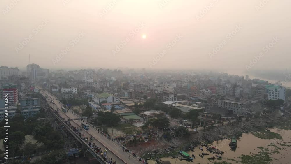 Aerial: bridge over river with city view and morning sun - aerial establishing drone flight shot Aerial: bridge over river with city view and morning sun - aerial establishing drone flight shot