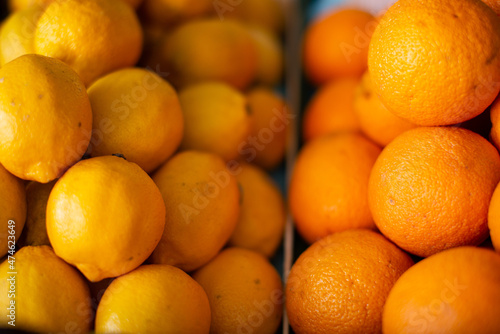 Ripe oranges are beautifully stacked on the counter.