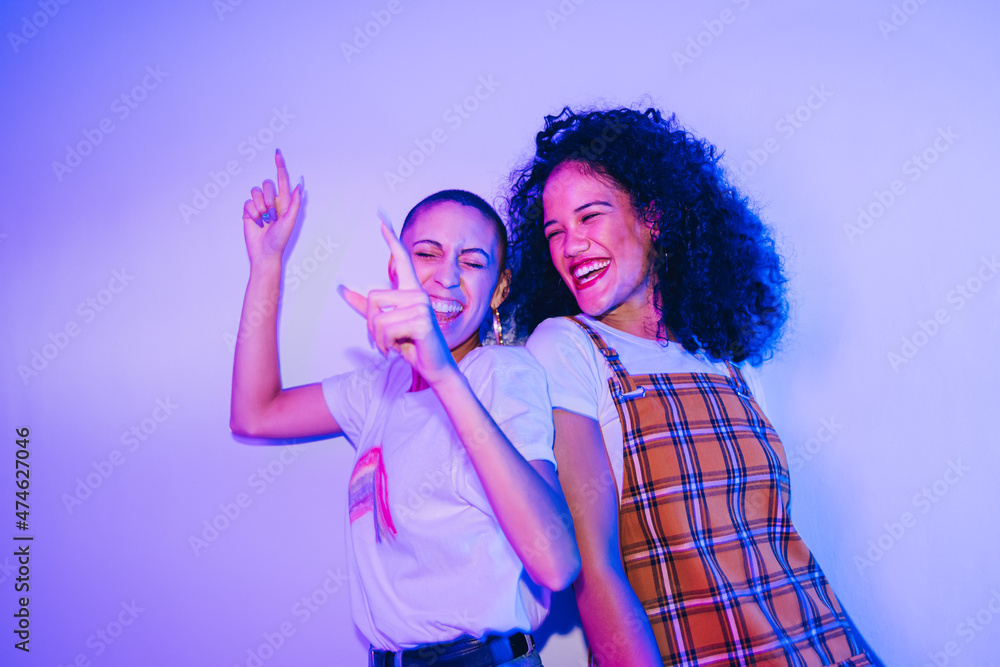 Best friends dancing to their favourite song at a party Best friends dancing to their favourite song at a party