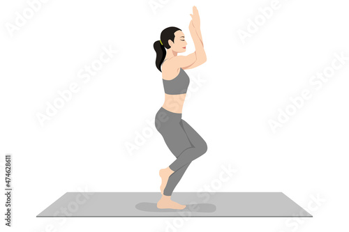 Eagle Pose, Beautiful girl practice Garudasana, Young attractive woman practicing yoga exercise. working out, black wearing sportswear, grey pants and top, indoor full length, calmness and relax.