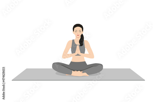 Easy Pose Prayer Hands, Beautiful girl practice Sukhasana Namaste Hands. Young attractive woman practicing yoga exercise. working out, black wearing sportswear, grey pants and top, indoor full length,