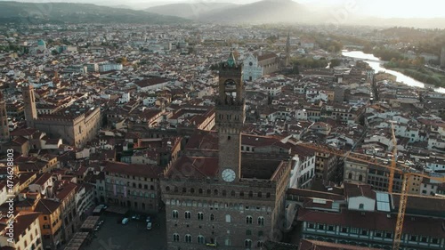 Palazzo Vecchio building overlooking Piazza della Signoria during sunrise, Florence, aerial photo