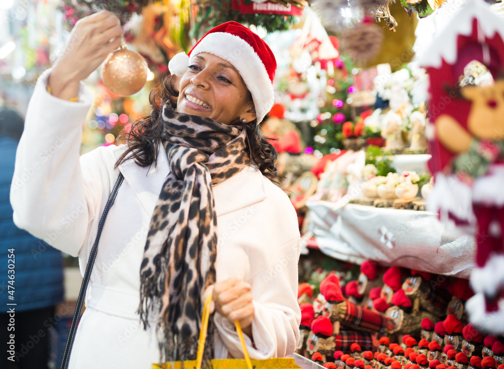 Woman are preparing for Christmas and choosing balls on the tree