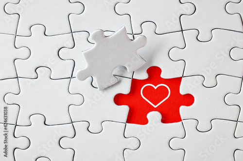 A heart shape on missing puzzle piece. To find love