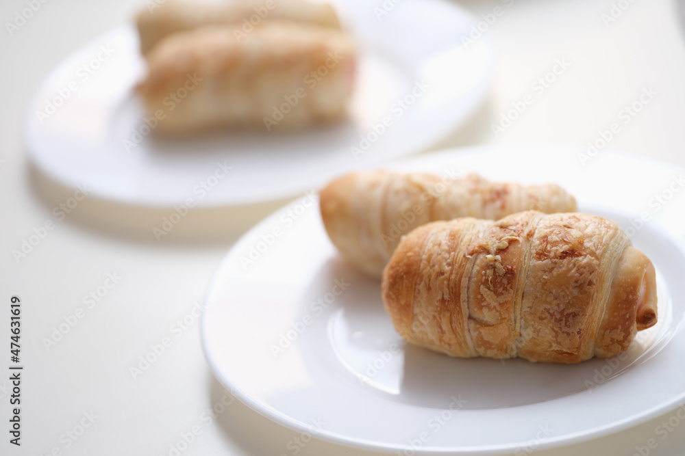 Delicious pigs in a blanket on a white plate Delicious pigs in a blanket on a white plate