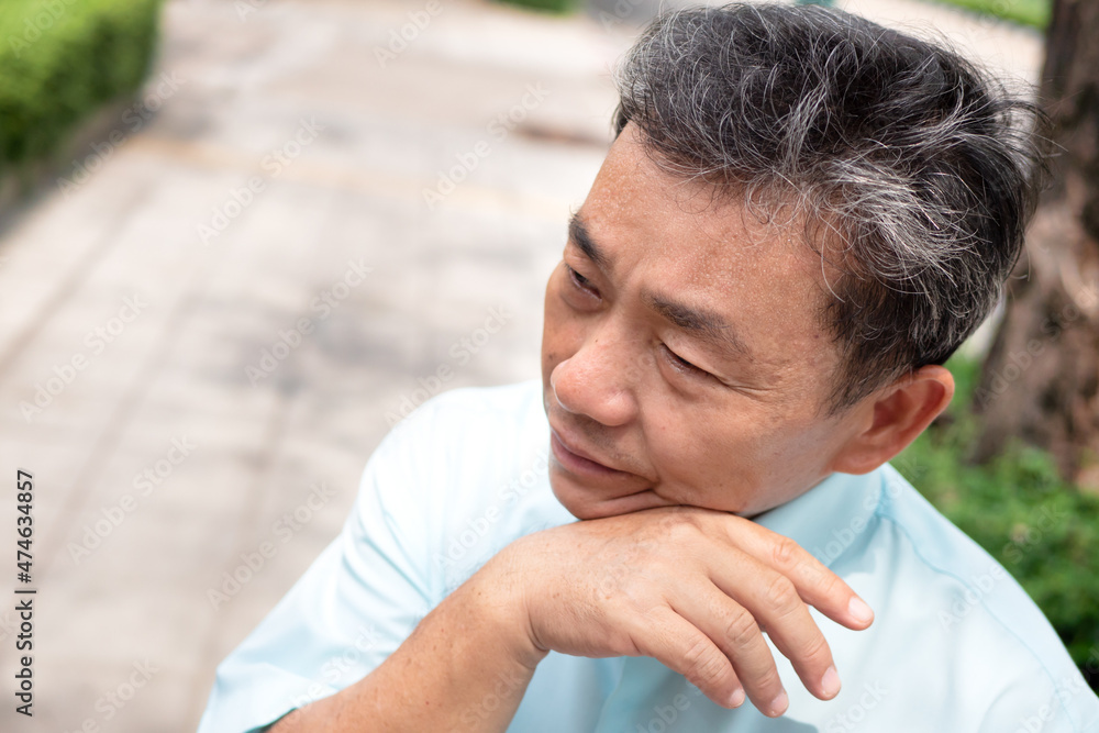 old man sweating due to hot weather, heatstroke, strong uv light or sunburn old man sweating due to hot weather, heatstroke, strong uv light or sunburn