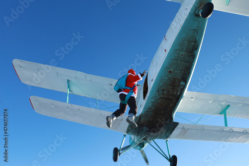 Fototapeta Naklejka Na Ścianę i Meble -  Skydiving. Santa Claus is flying near an airplane.